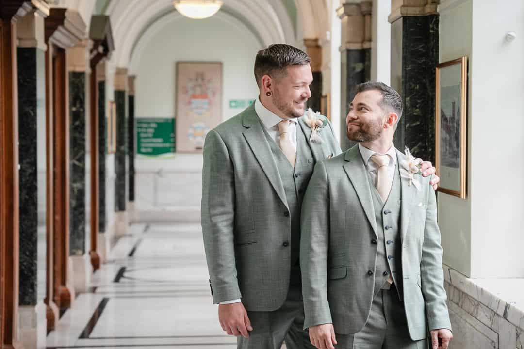 Two men in stylish suits after their wedding at islington town hall, by a queer wedding photographer