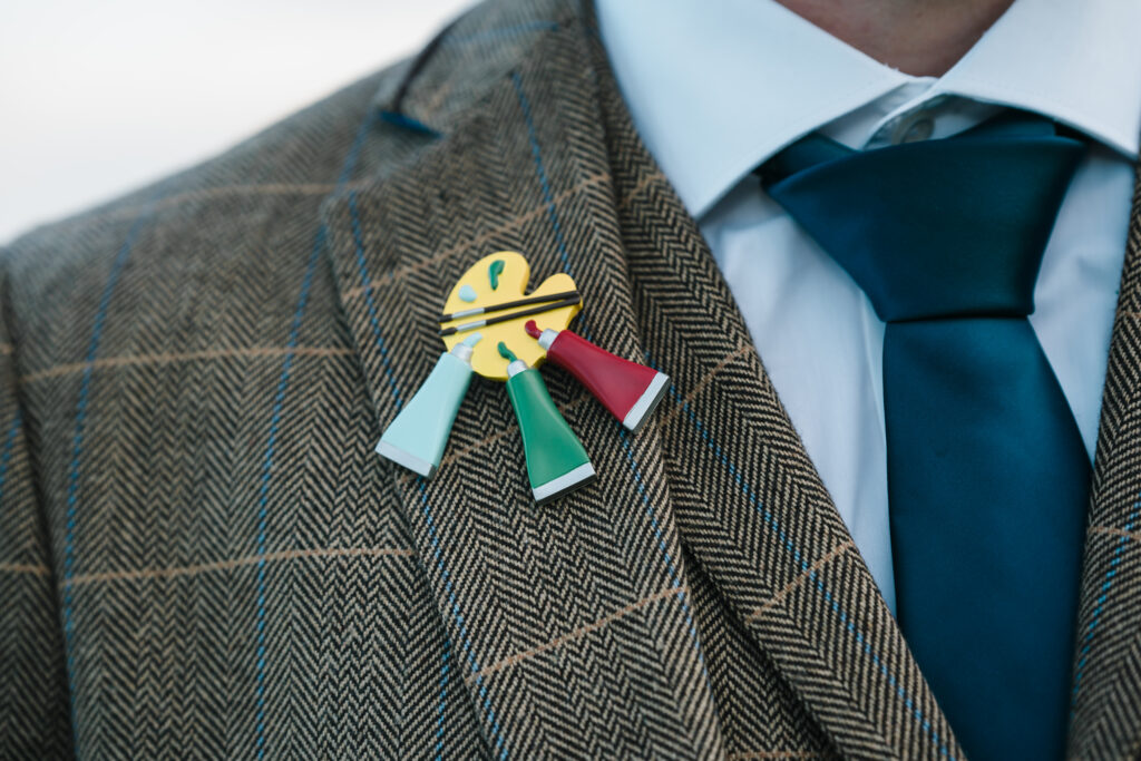 A broach in the shape of an artist’s paint pad in the style of that worn by Tom baker in Doctor Who