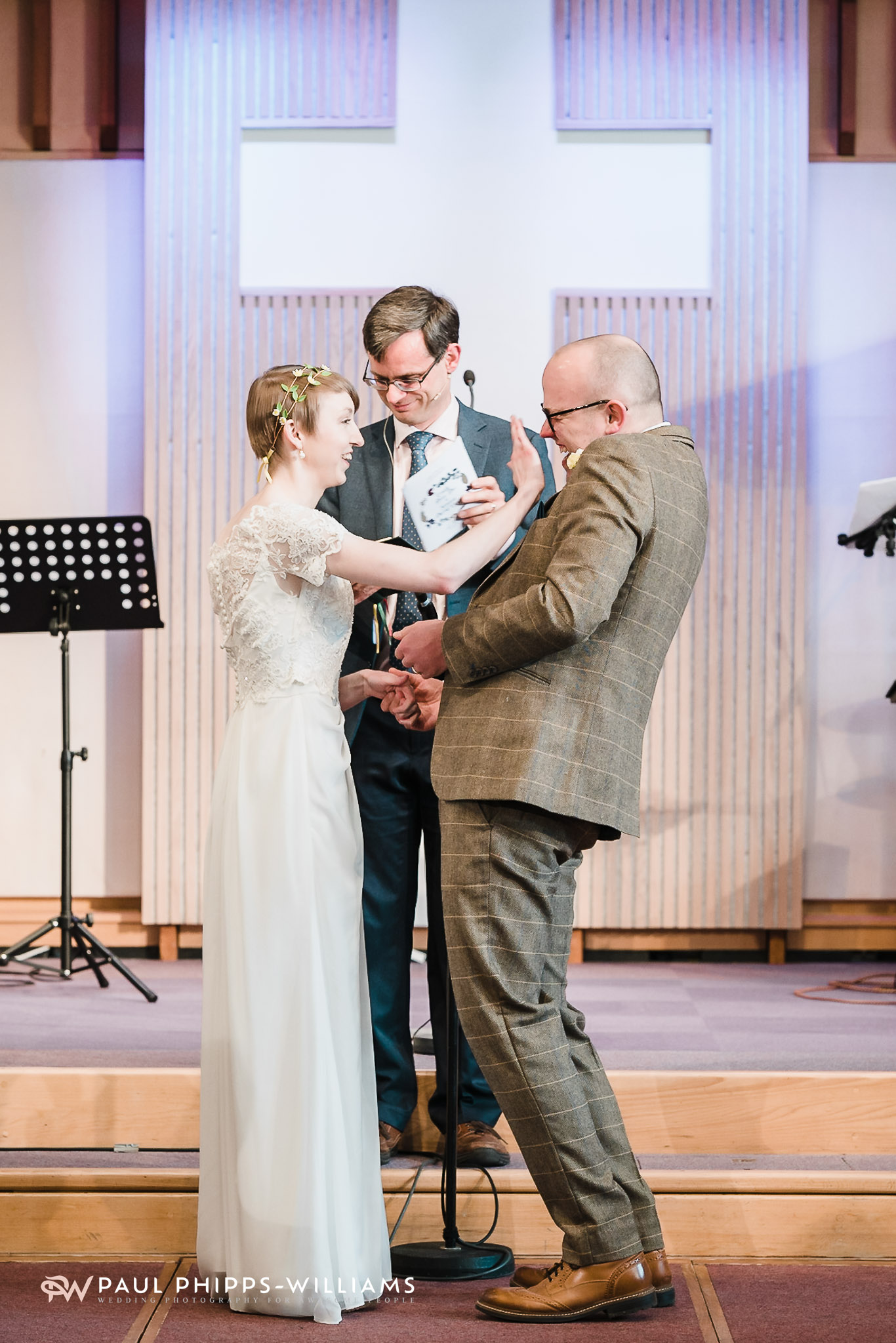Emily wipes a tear as they laugh at the altar