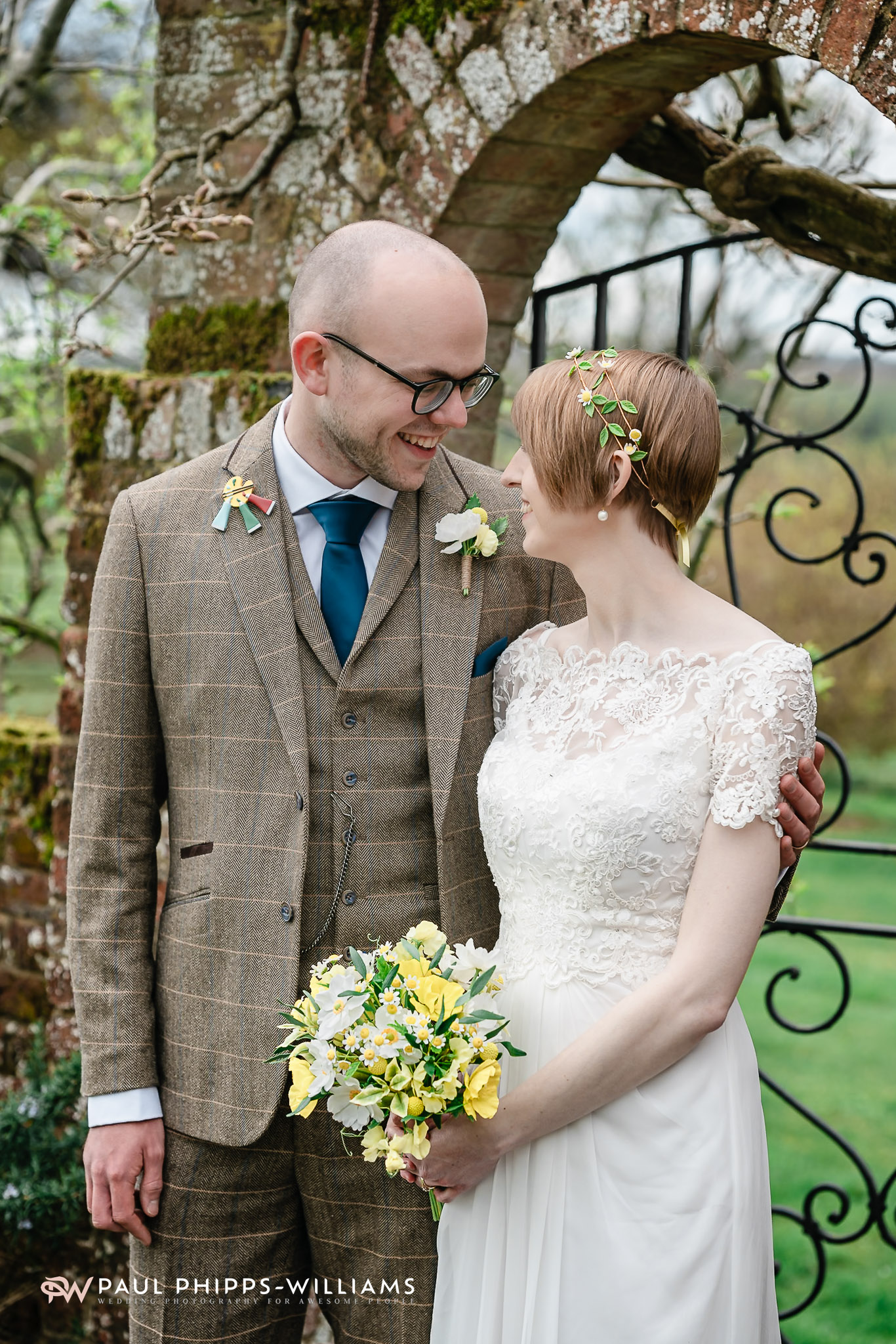Couple standing by the garden arch at Barford Park Barn