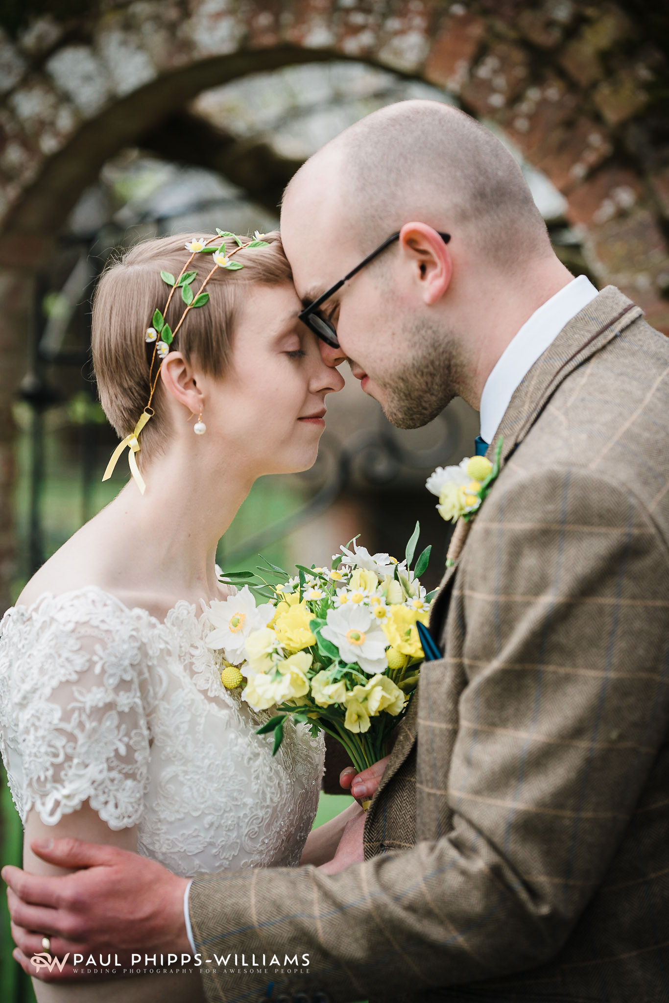 Couple standing by the garden arch at Barford Park Barn