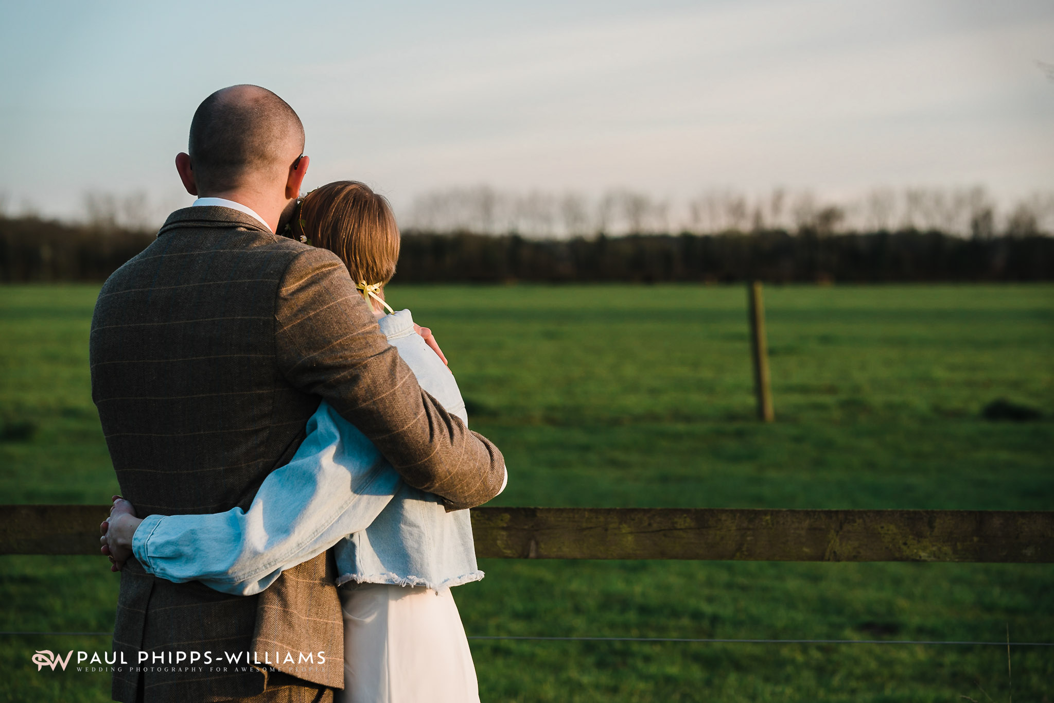 Bride and groom hug at winter wedding at Barford Park Barn