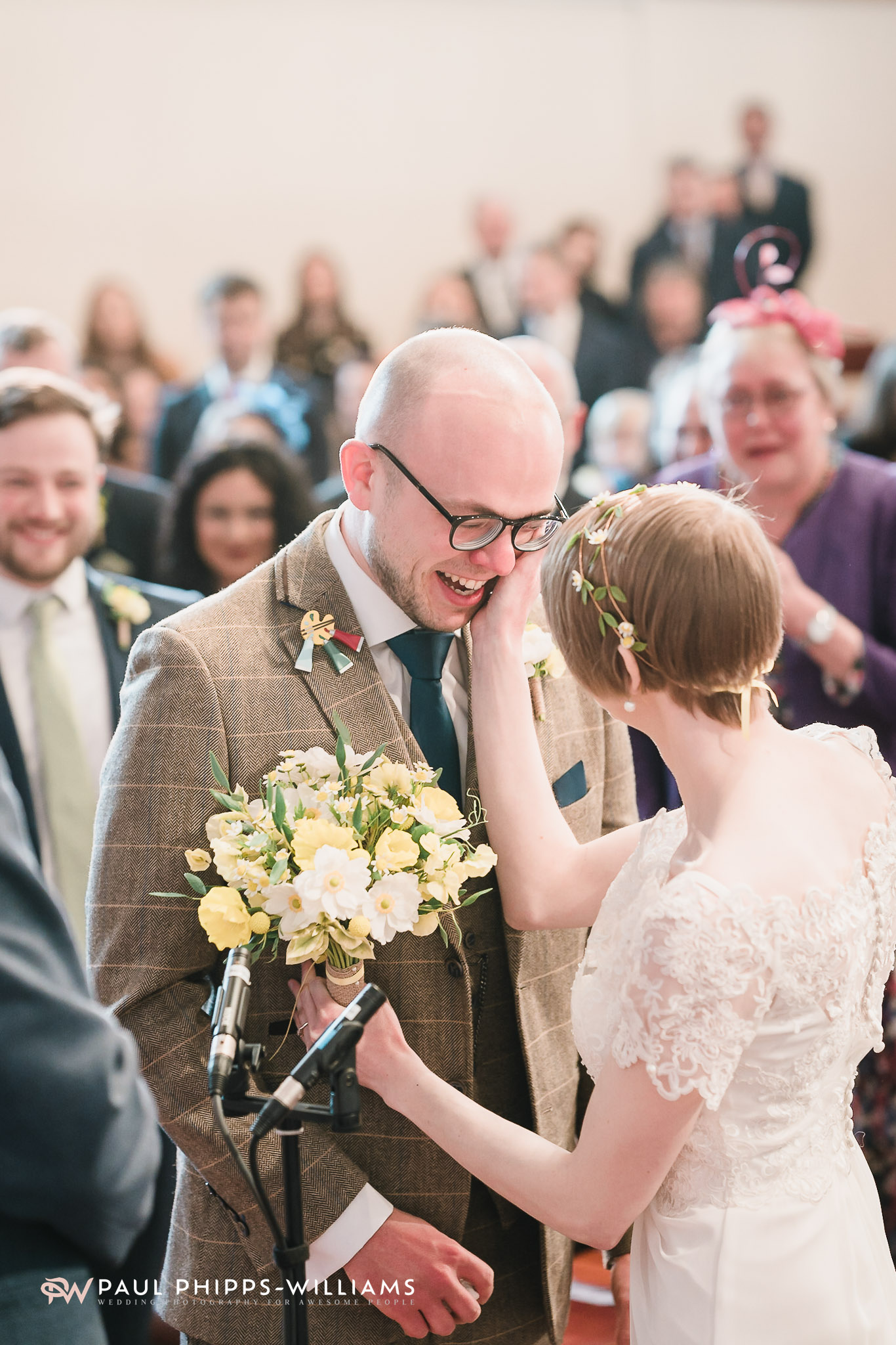 Emily touches Sim's face as he gets emotional during the service