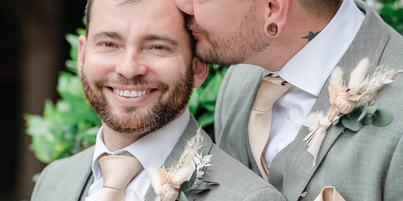 Two grooms kiss after their wedding at Islington Town Hall