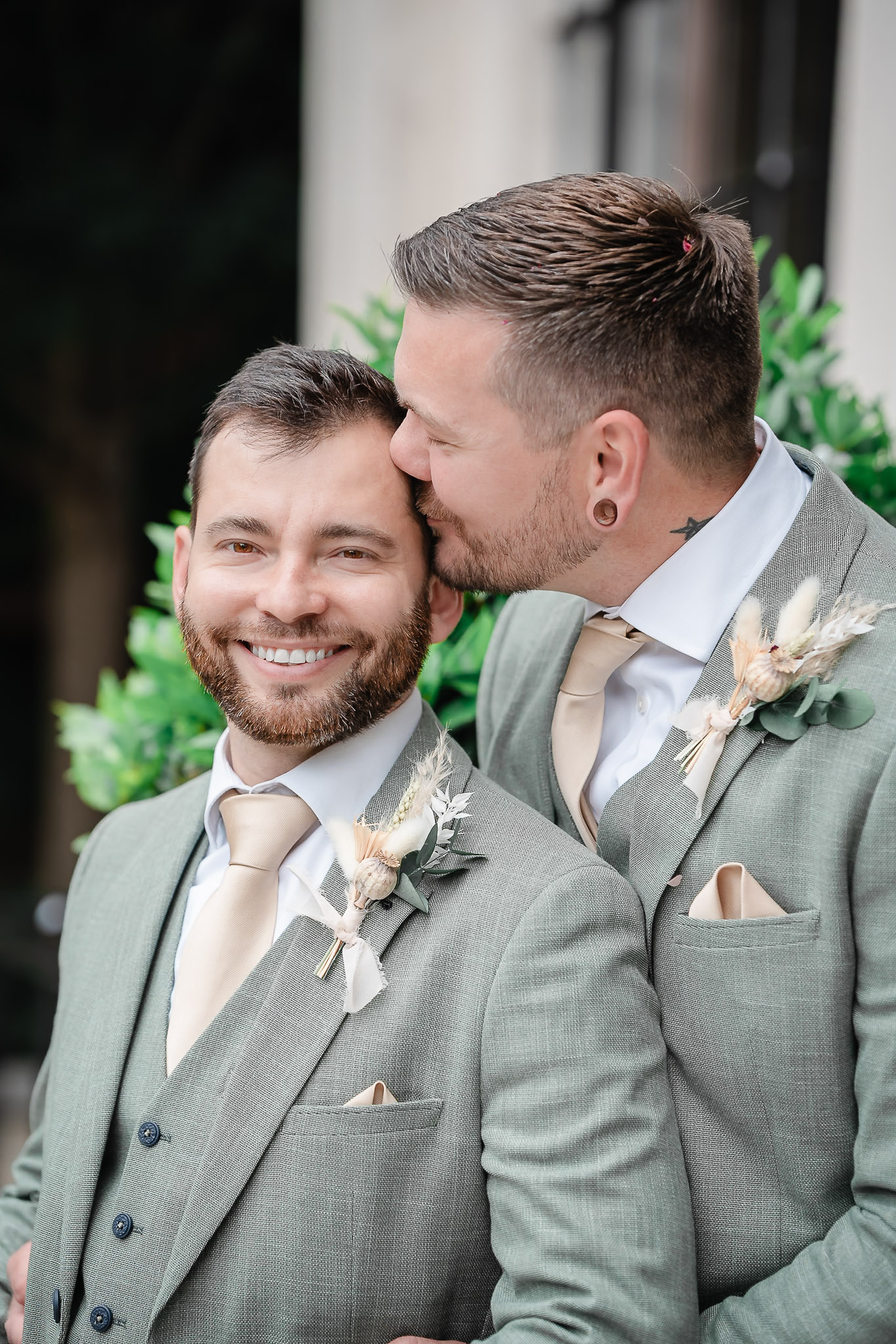 Two grooms kiss after their wedding at Islington Town Hall