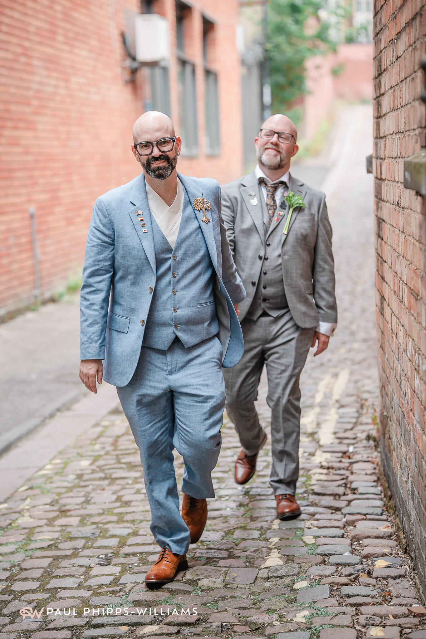 A same sex couple walking down the street in Derby after their wedding at Derby Registry office