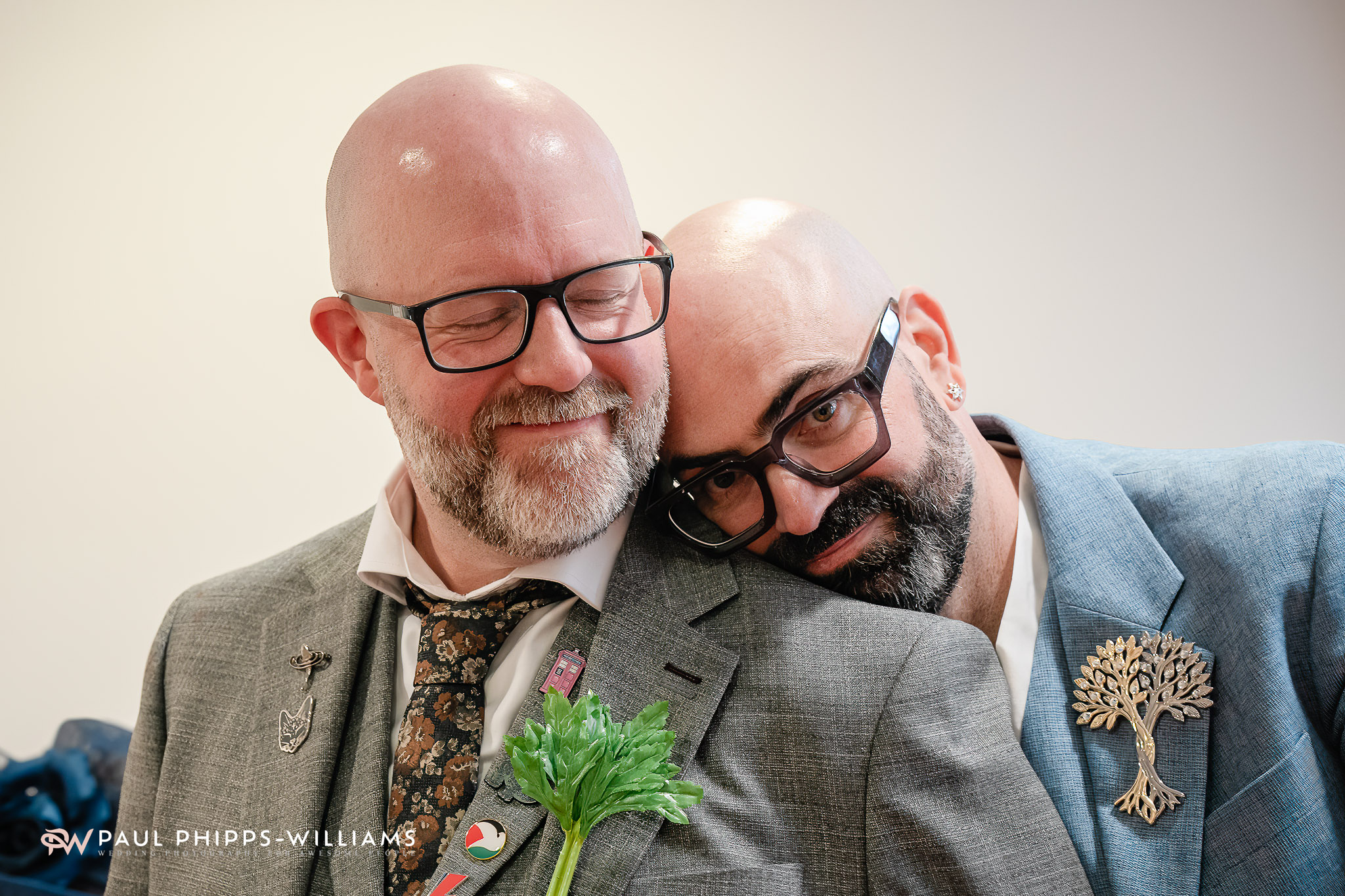 Two grooms at derby Registry Office. One has his head on the other's shoulder.