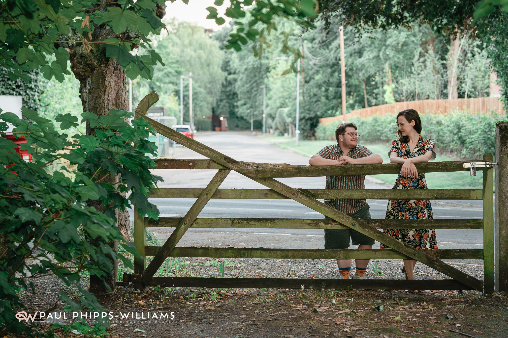 Fio and Georgia lean at the gate to a Manchester Park