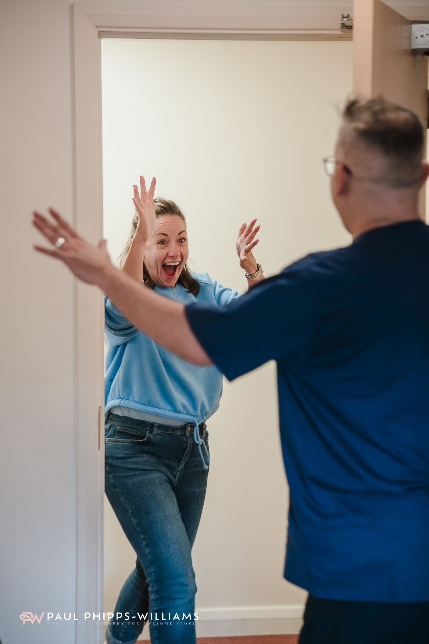 A woman screams with delight as she enters a groom's room