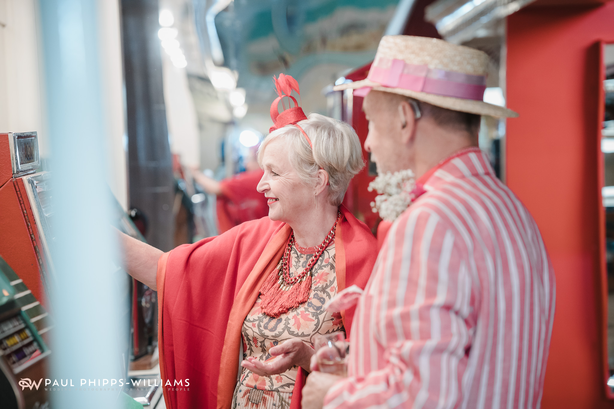 Wedding guests play with slot machines during a wedding at Wookey Hole caves