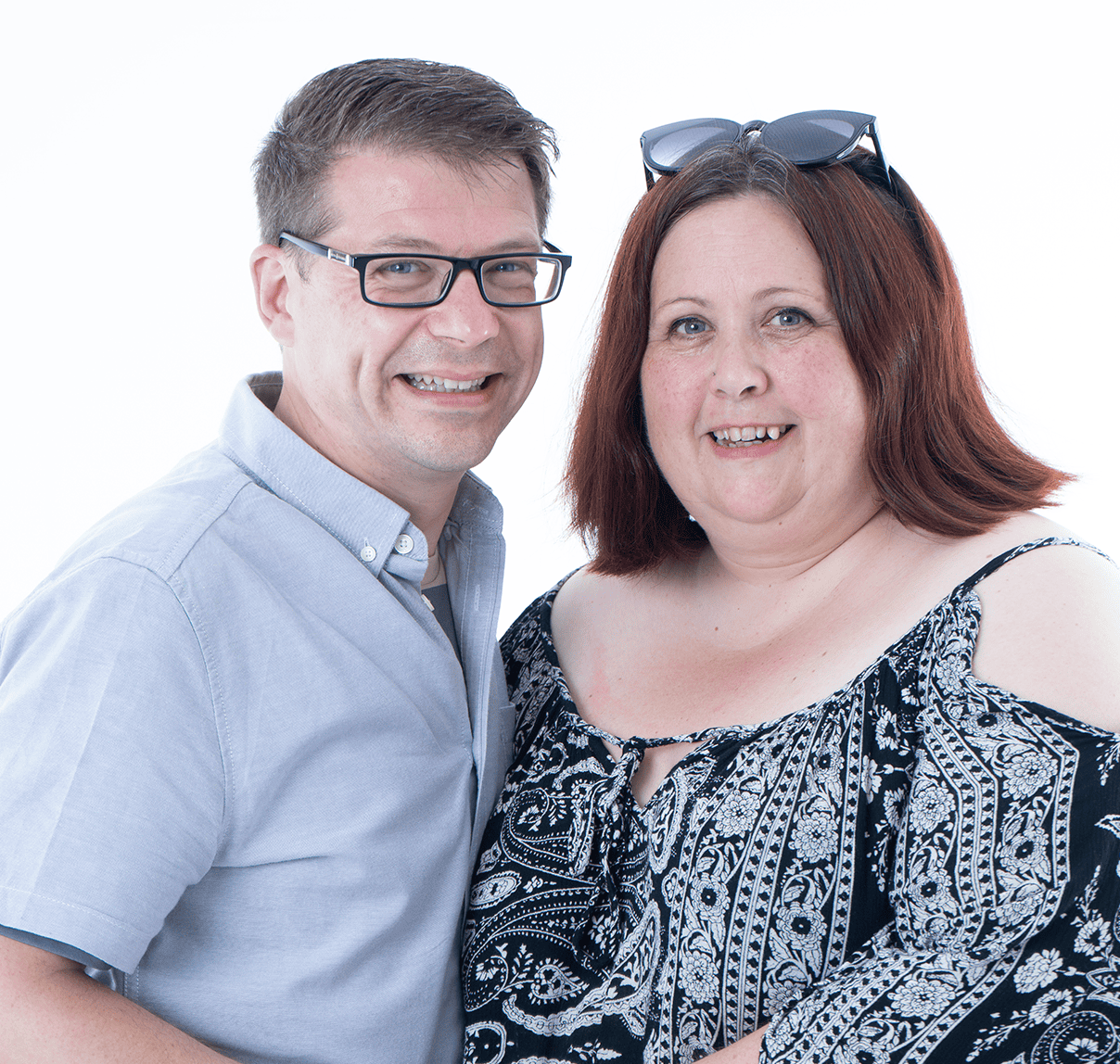 Smiling couple portrait showcasing natural expressions and vibrant personalities.