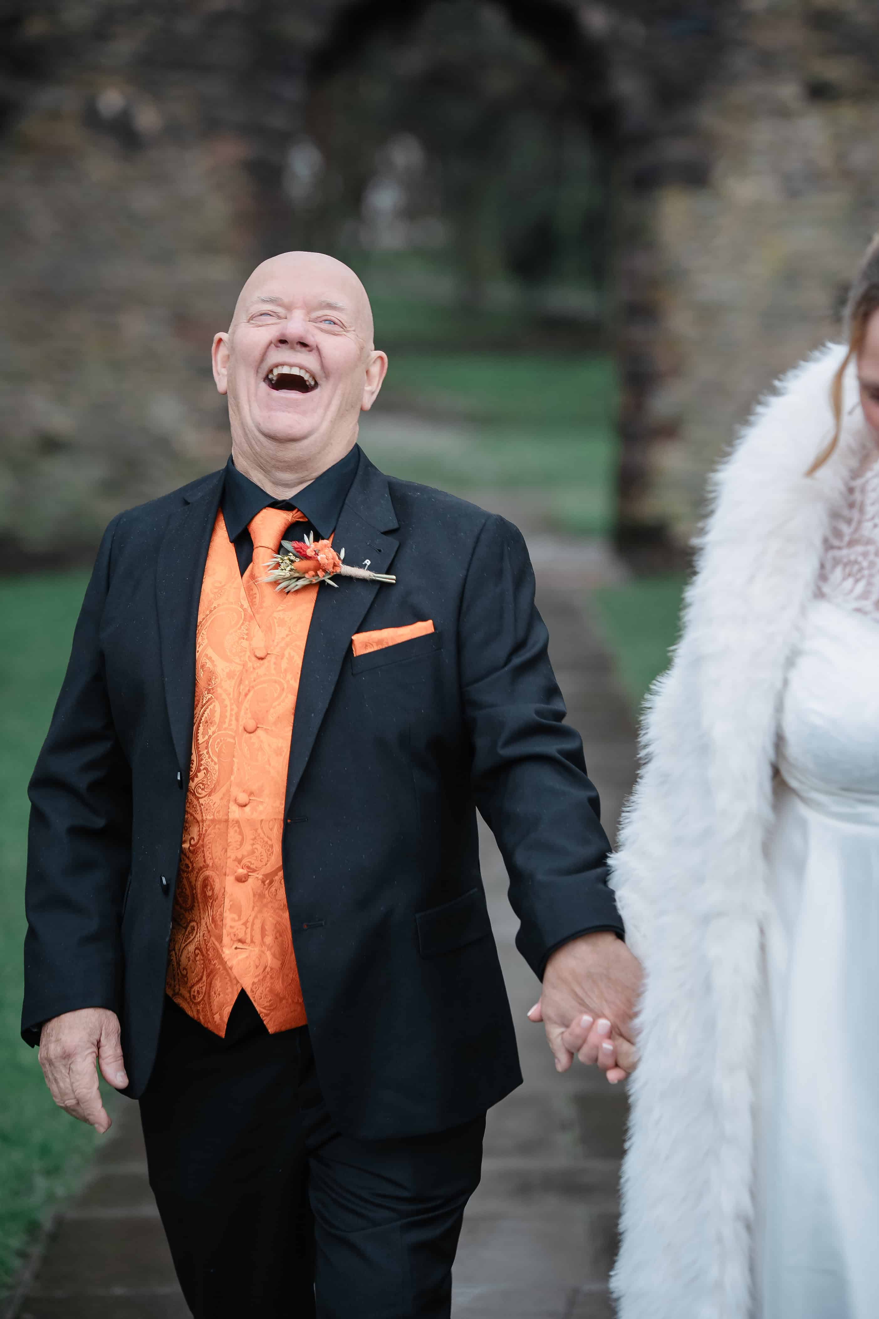 A groom after his wedding in the ruins at Priory Park Dudley
