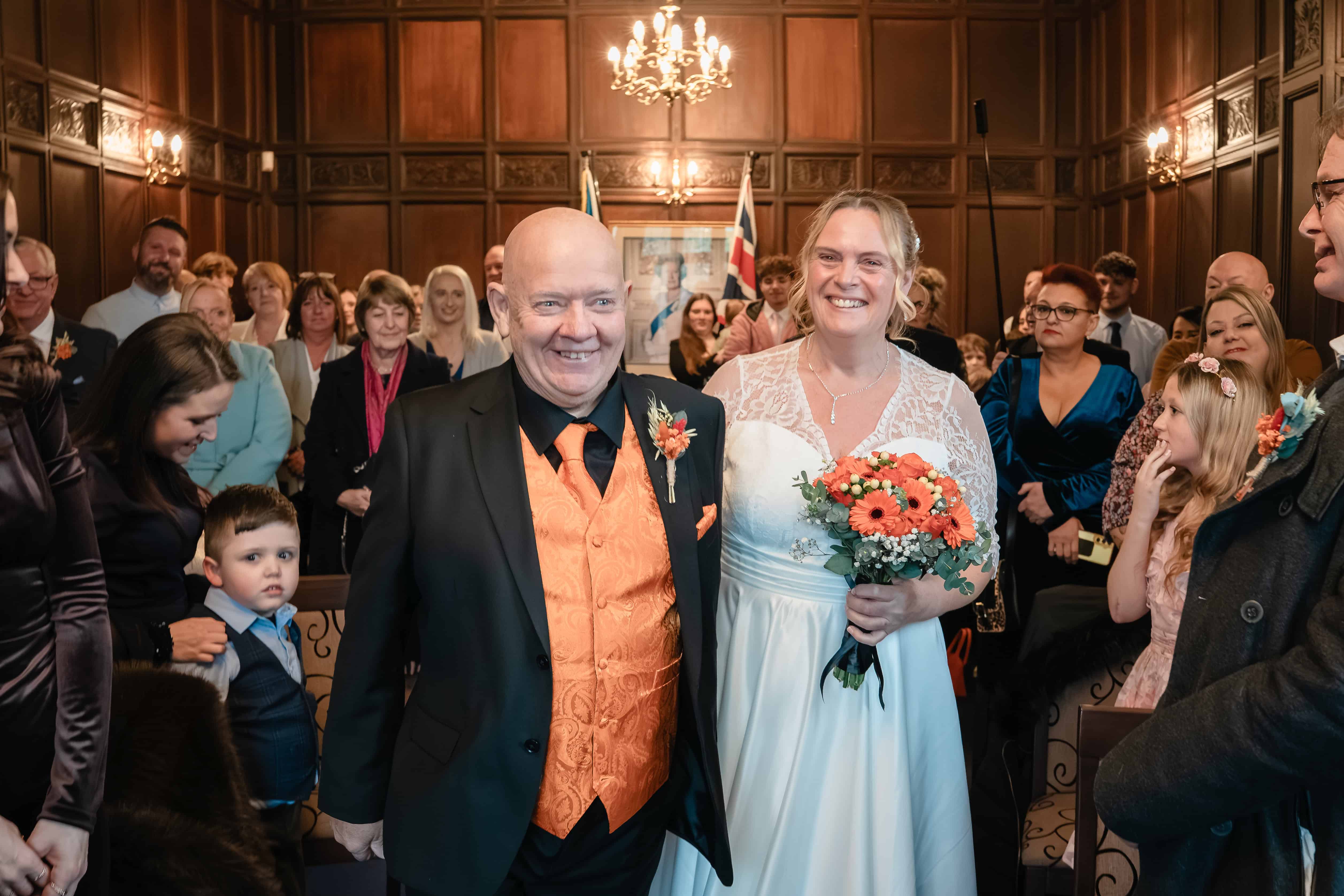 A bride and groom walk down the aisle at Dudley Registry Office