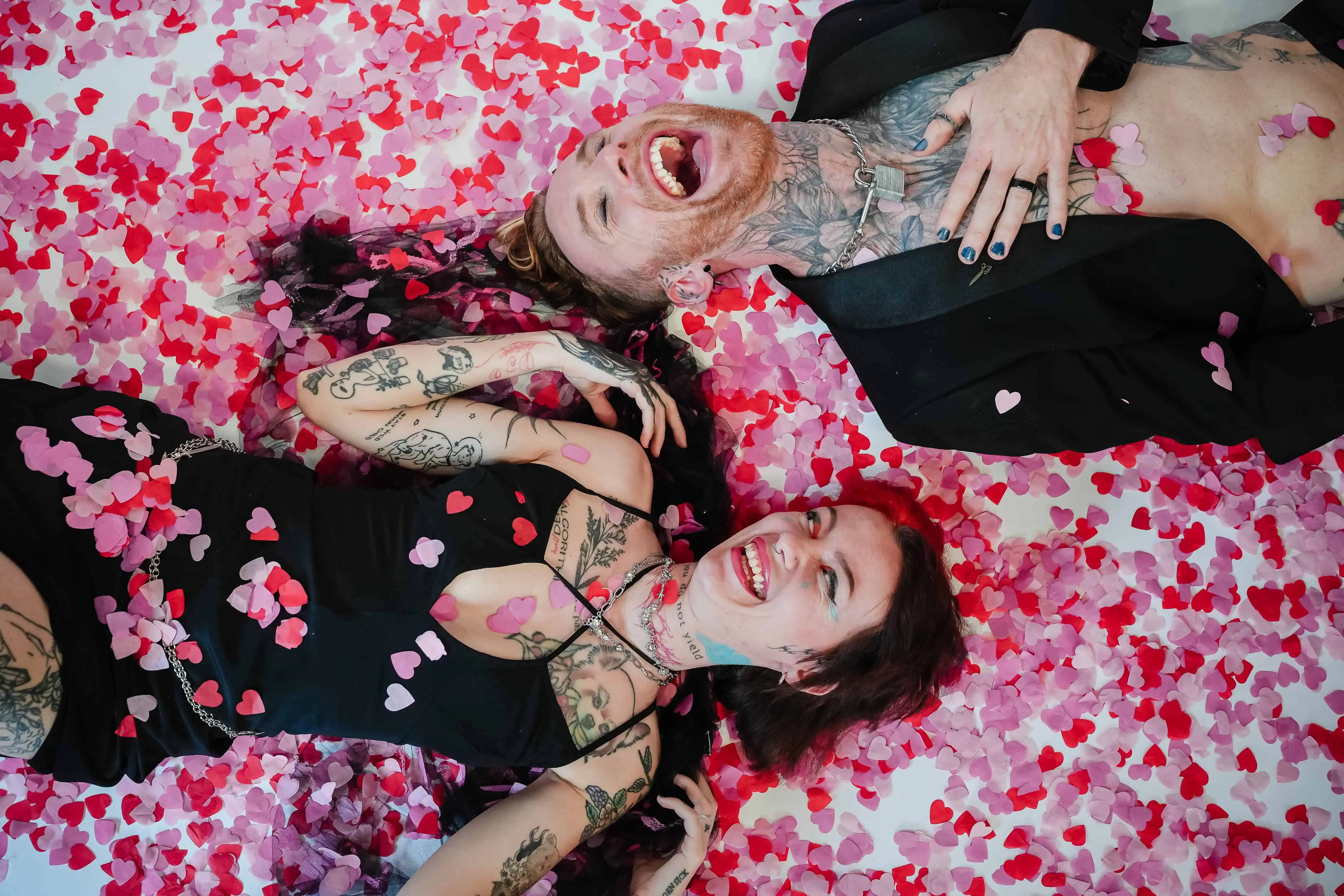 wedding photography - birmingham - two people lying on a bed of confetti