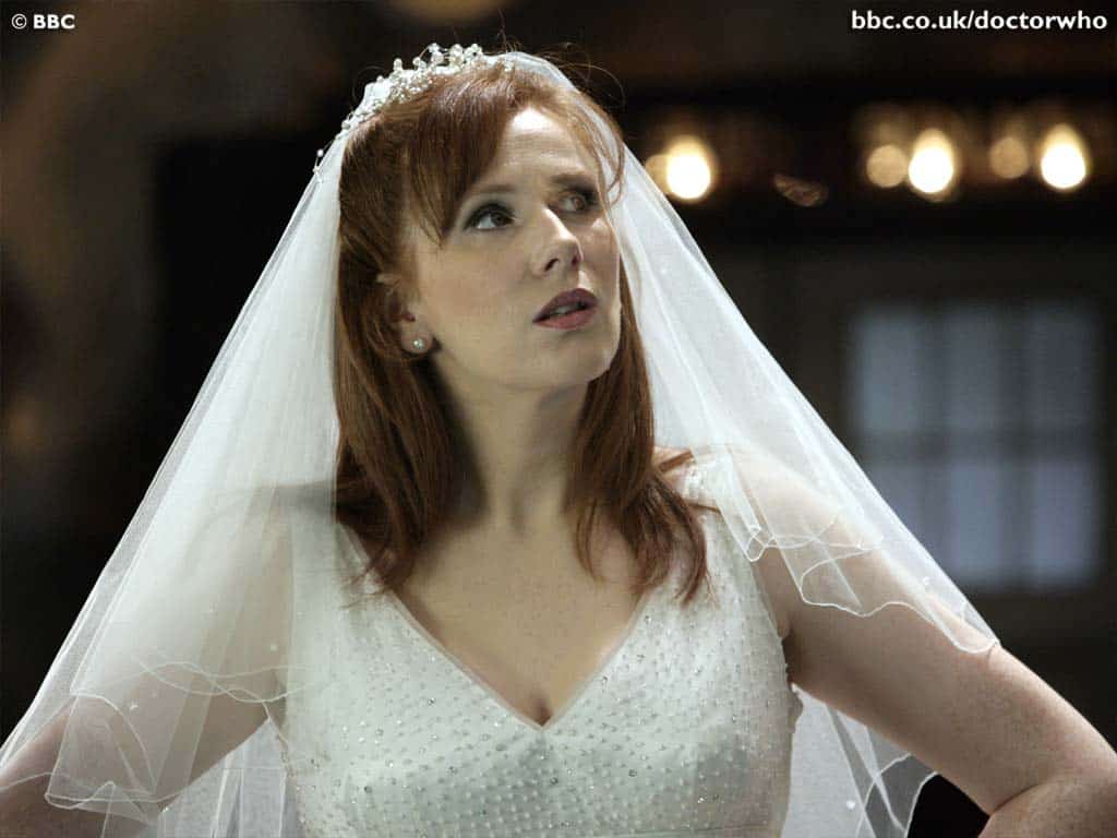 Wedding bride portrait with veil and elegant dress, indoor setting.
