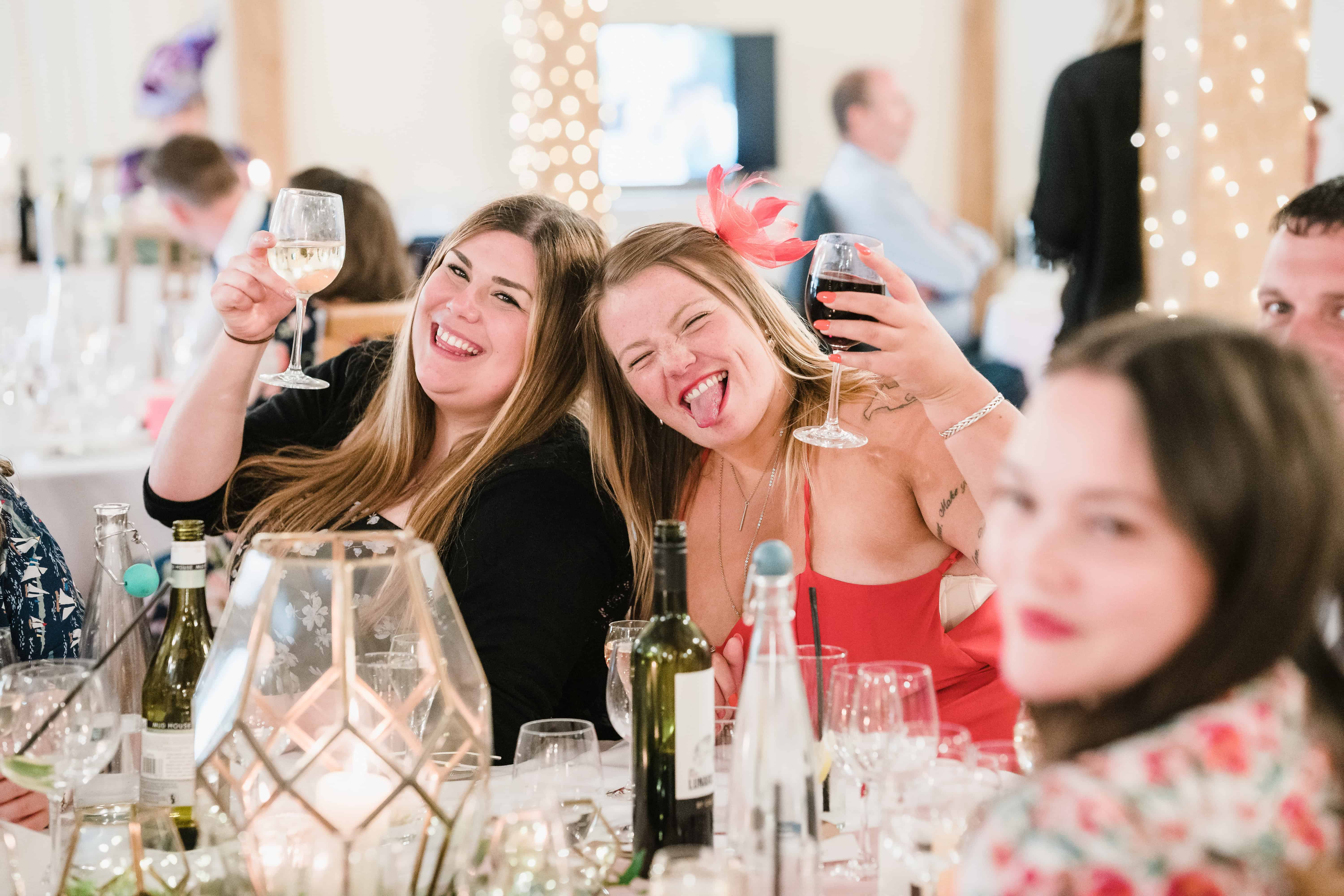 girls saying cheers at a wedding reception