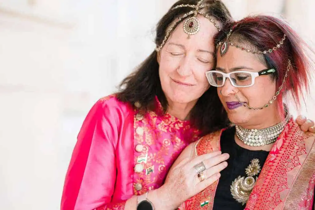 two women after their wedding in London looking peaceful as one places her hand on the other's shoulder