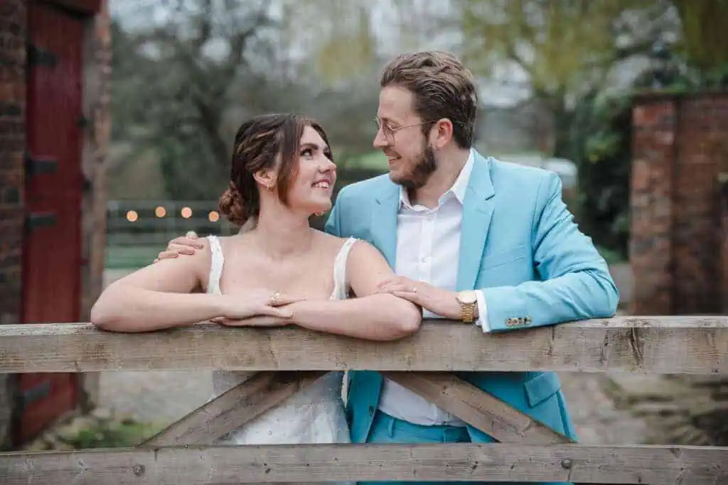 bride and groom at a gate on their wedding day