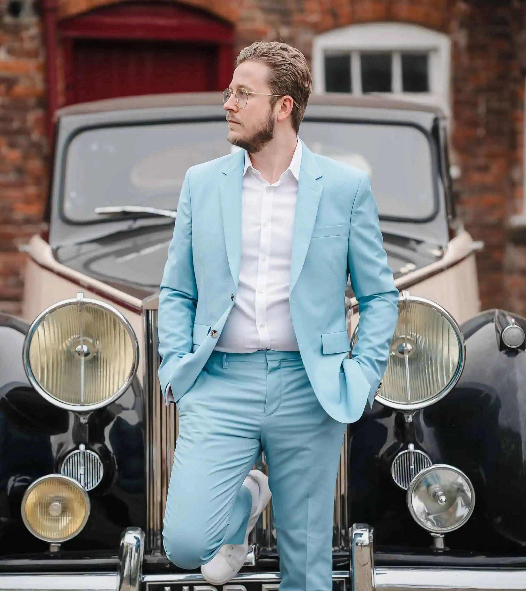 man in front of a classic car before he gets married in Birmingham