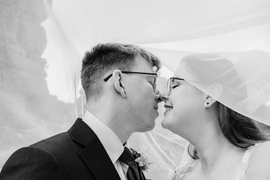 a bride and groom kiss under the veil at priority park in Dudley