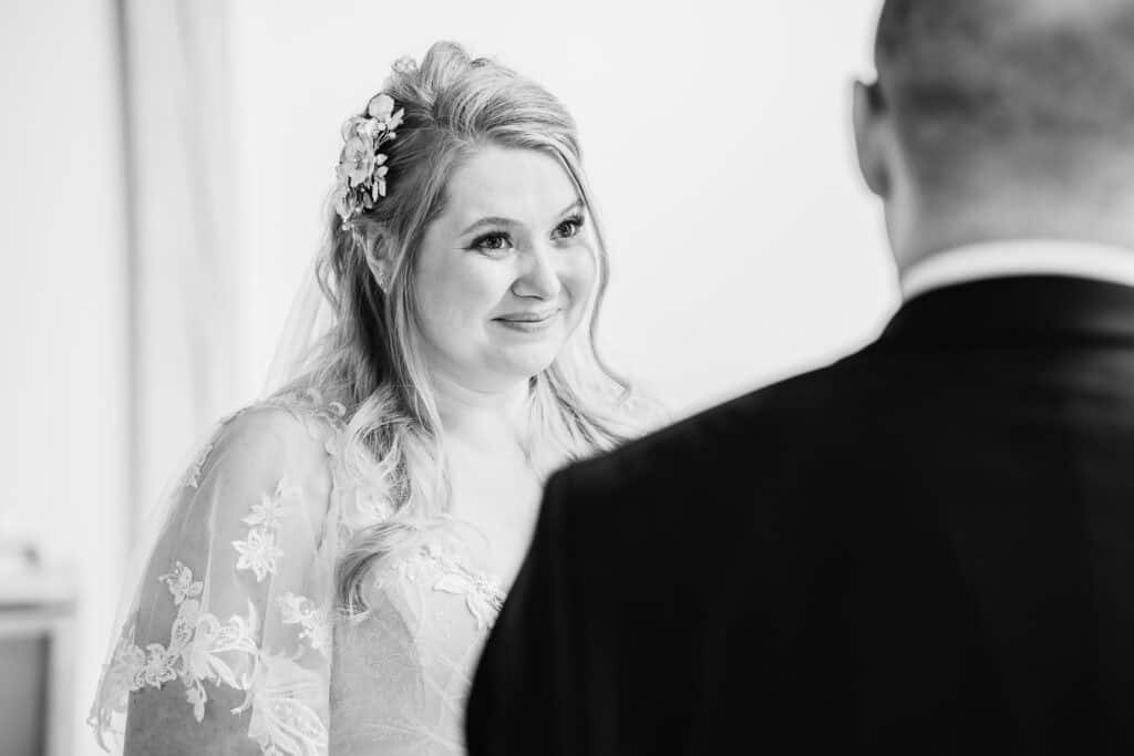 a bride looks at her groom during her Warwickshire wedding